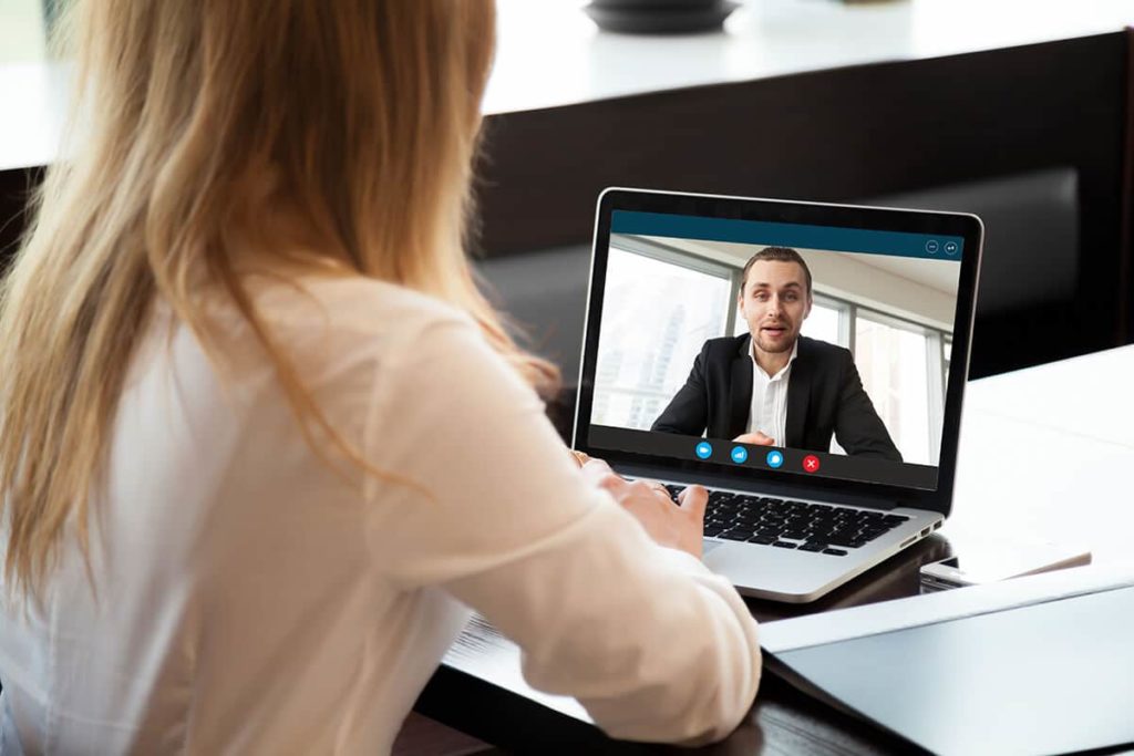 Business-woman-video-conferencing-with-business-man