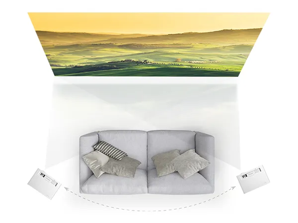 birdseye view of a couch and two projectors  throwing video on a screen in a home theater