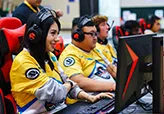 a line of students in yellow jerseys using ViewSonic monitors to compete in e-sports