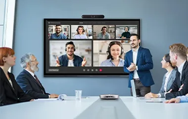 Man conducting a meeting in front of a group of people using a ViewBoard to also connect to remote attendees