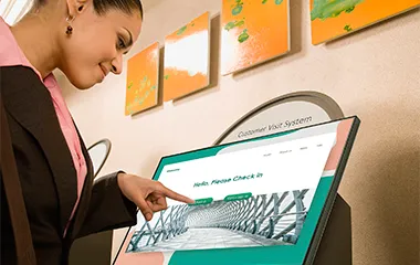 Woman in a hospital using a touch screen display as a wayfinding tool