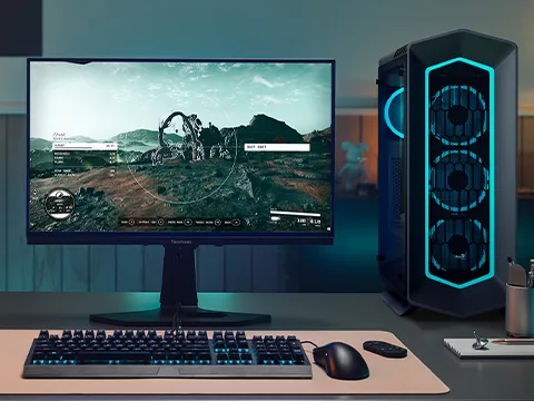 a monitor sitting next to a computer tower on a desk