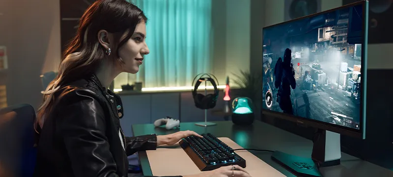 woman sitting at desk using a ViewSonic monitor to play a game