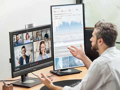 someone using dual monitors for a video call and a presentation at once