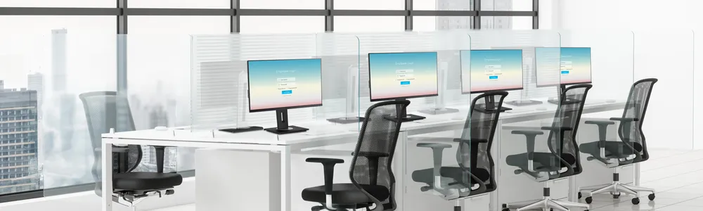 a row of monitors and chairs in an office