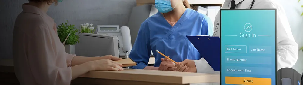 a nurse and a doctor help a patient at a desk