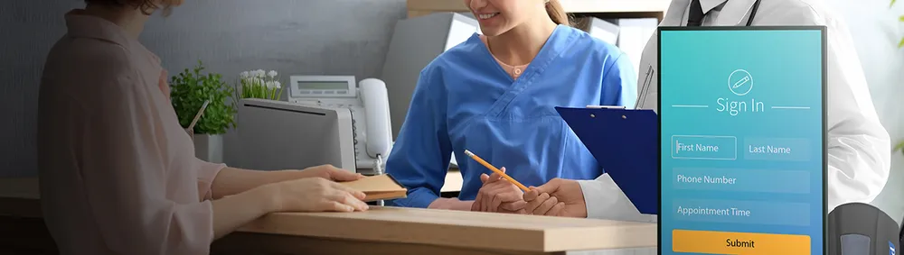 a nurse and a doctor help a patient at a desk