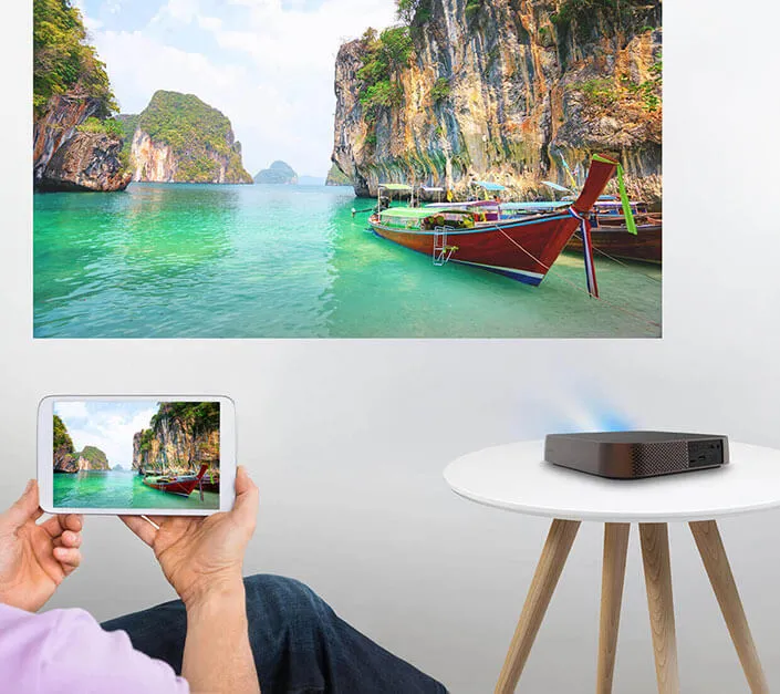 a tablet wirelessly casting a video to a smart projector