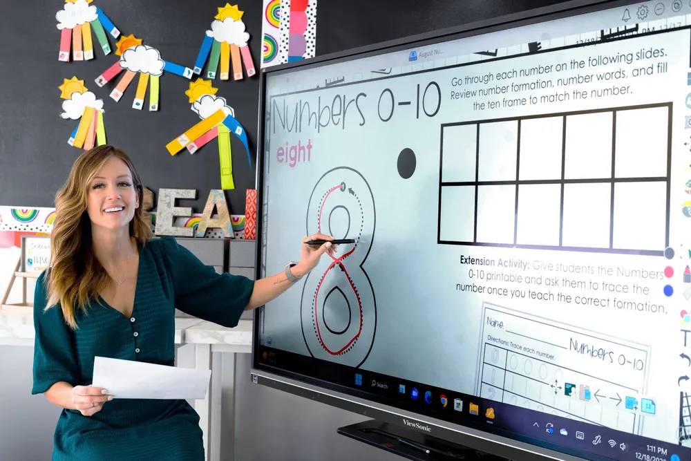 a teacher using the touch screen on a viewboard to instruct the classroom