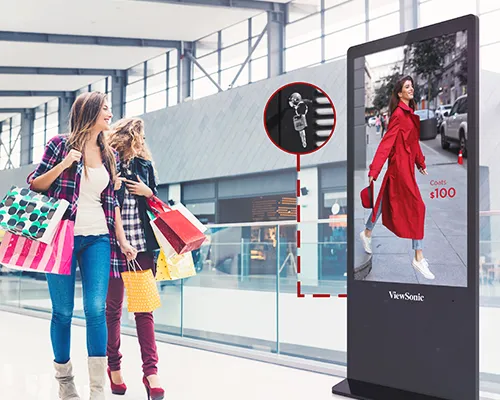 shoppers walking past an advertisement on a kiosk in a shopping center