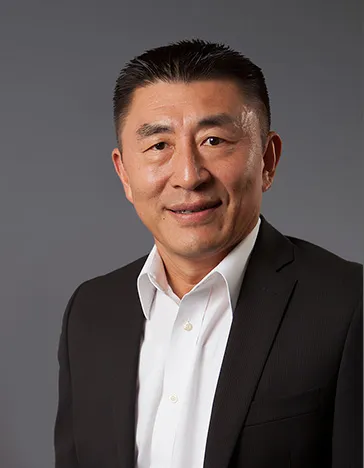 headshot of sung yi in a suit