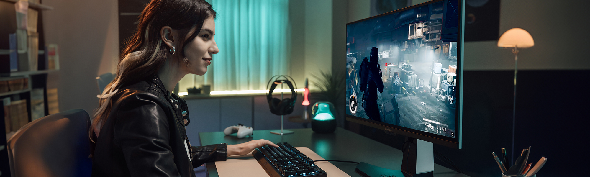 woman sitting at desk using a ViewSonic monitor to play a game