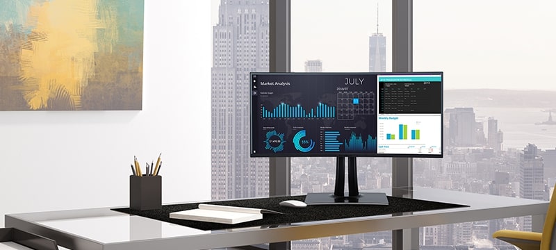 an ultrawide monitor on the desk in an executive office