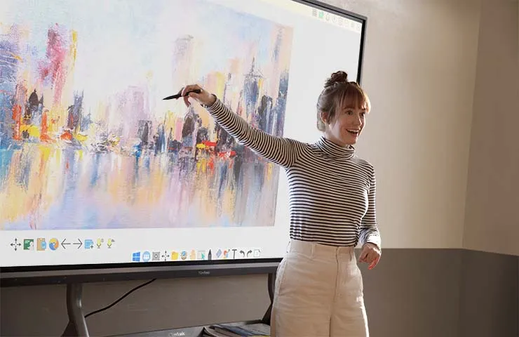 someone pointing at artwork being displayed on a large format display